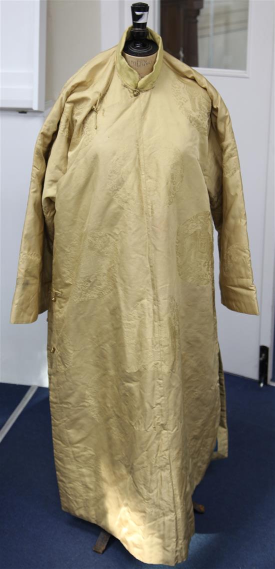 A Chinese yellow silk damask quilted robe, late 19th / early 20th century,